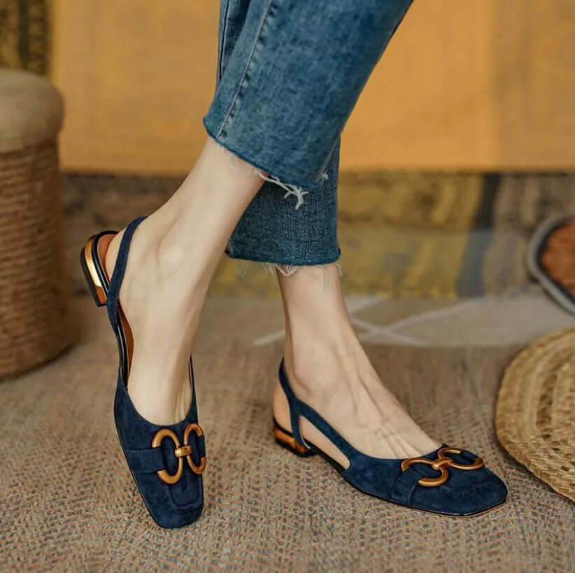 Slingback loafers in beige, cream, and navy blue with gold buckle detail, square toe, and low heel with metallic accent