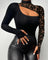 Woman wearing a sleek black asymmetric top with lace sleeve and diagonal cut-out