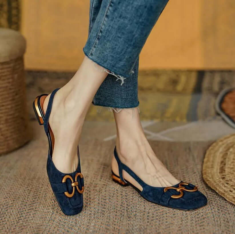 Slingback loafers in beige, cream, and navy blue with gold buckle detail, square toe, and low heel with metallic accent