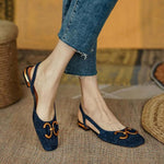 Slingback loafers in beige, cream, and navy blue with gold buckle detail, square toe, and low heel with metallic accent